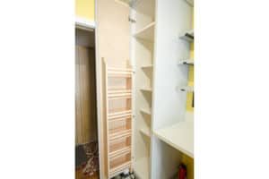 8 foot tall pantry door with shelf inside as well as custom wood shelf on the back of the door.